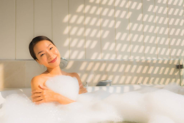 Portrait young asian woman relax take a bath in bathtub for spa concept - Photo, Image