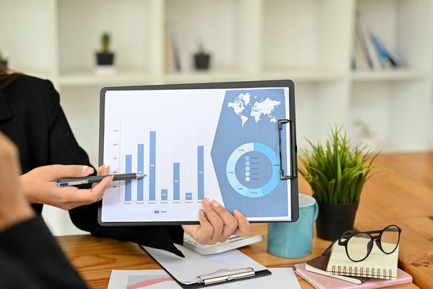 imagen de primer plano, Una mujer de negocios presentando, mostrando y explicando el gráfico financiero y gráfico en el informe en la oficina. - Foto, Imagen