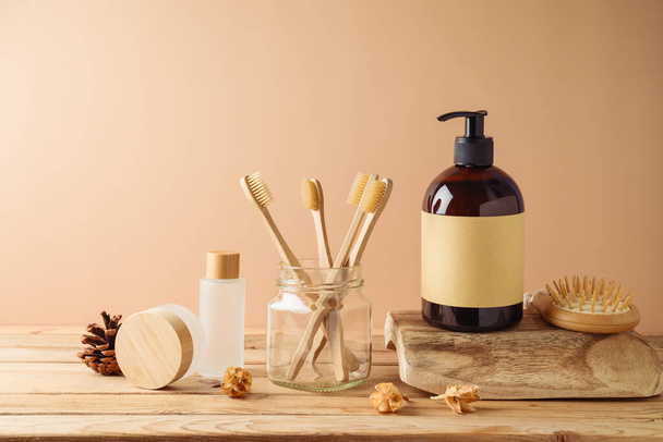 Natural organic cosmetics bottles and eco friendly toothbrush for mock up packaging design on wooden table over beige background - Foto, Imagen