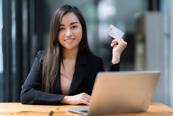 Woman using online payment and holding credit card. Online Shopping concept - Photo, Image