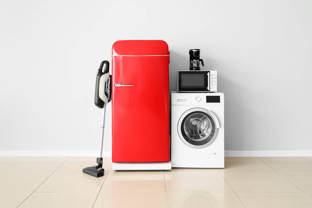 Modern household appliances near light wall in room - Photo, Image