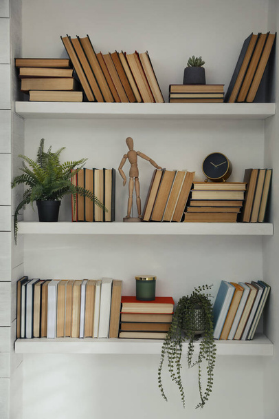 Many shelves with different decor in room. Interior design - Foto, Imagem