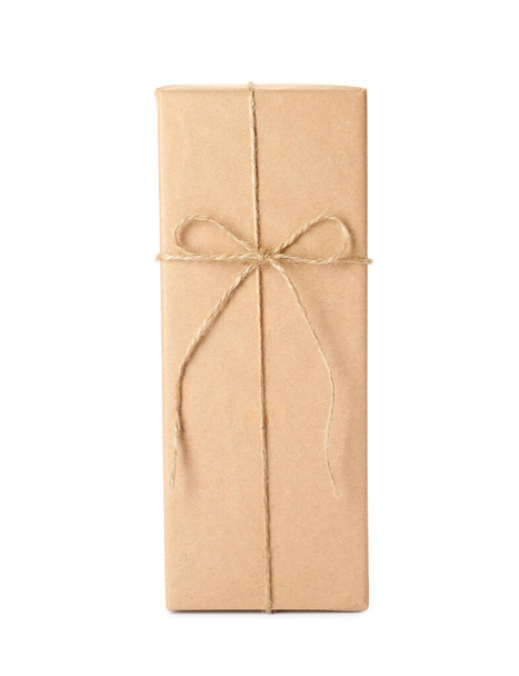 Parcel wrapped with kraft paper and twine isolated on white - Fotó, kép