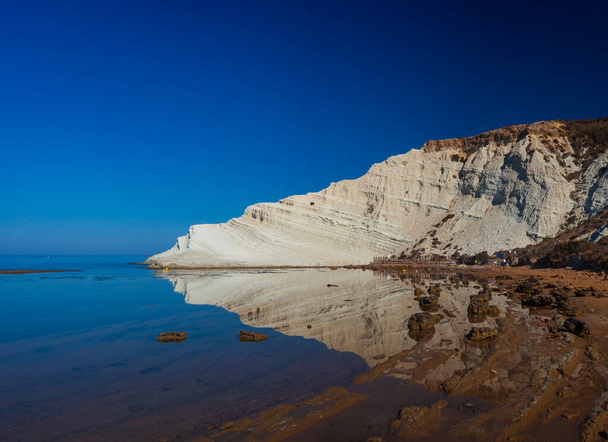 View of the limestone white cliffs with beach at the Scala dei Turchi in English Stair of the Turks or Turkish Steps near Realmonte in Agrigento province. Sicily, Italy - Photo, Image