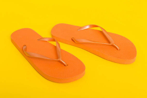 Beach accessories. Flip flops and starfish on colored background. Top view Mock up with copy space. - Photo, Image