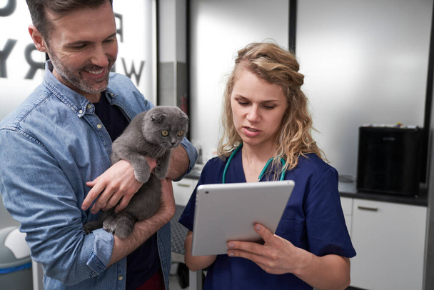 Samice veterinář ukazující lékařské testy na tabletu   - Fotografie, Obrázek
