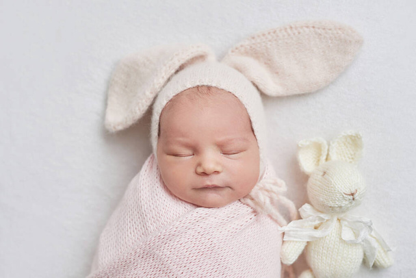 Newborn baby girl in bunny hat. Healthy child. Happy motherhood and parenting. - Zdjęcie, obraz
