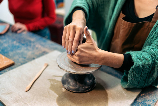 Stock photo of unrecognized person shaping clay in art pottery workshop. - Foto, Bild