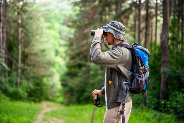 Image of man hiking and using binoculars. - Valokuva, kuva