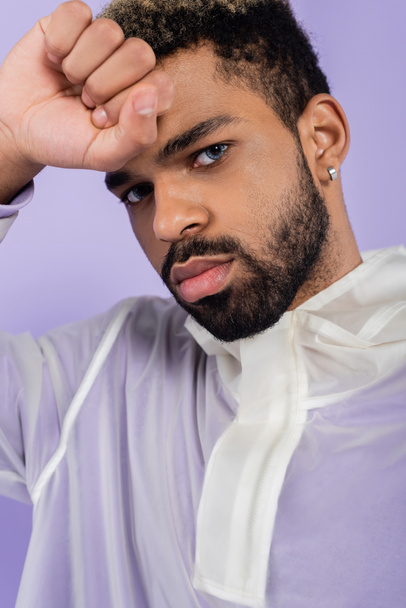 portrait of bearded and young african american man with blue eyes isolated on purple  - Foto, Bild