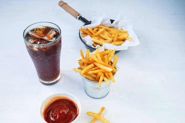 Fried french fries and ketchup with soft drinks on the table - Foto, Imagen