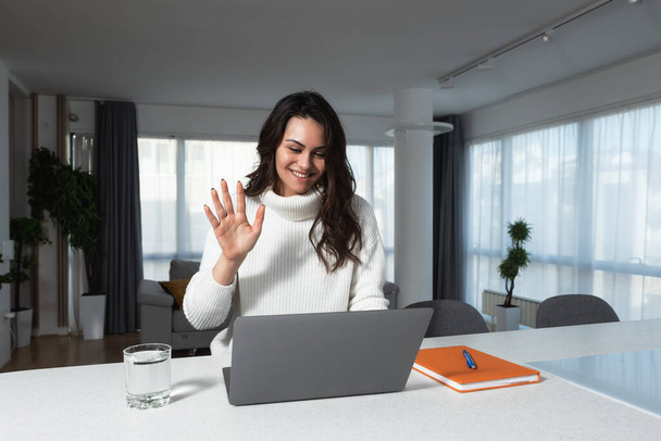 Online conference. Intelligent business woman using laptop making video call to business partner. Home office. Smart expert female working from home at computer for telecommunication. - Photo, Image