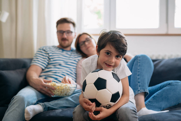 family watch soccer game at home together in living room - Fotoğraf, Görsel