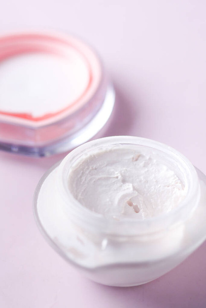 Close up of beauty cream in a pink container. - Photo, Image