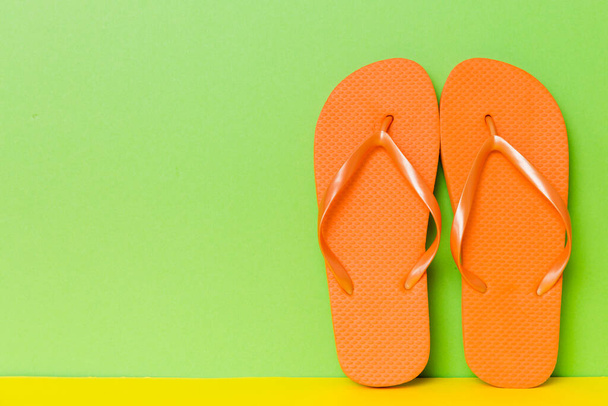 Beach accessories. Flip flops and starfish on colored background. Mock up with copy space. - Fotografie, Obrázek