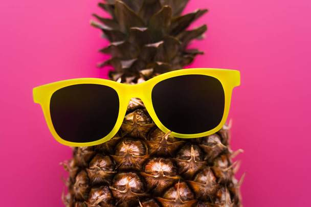 Top view of sunglasses on pineapple isolated on pink  - Valokuva, kuva