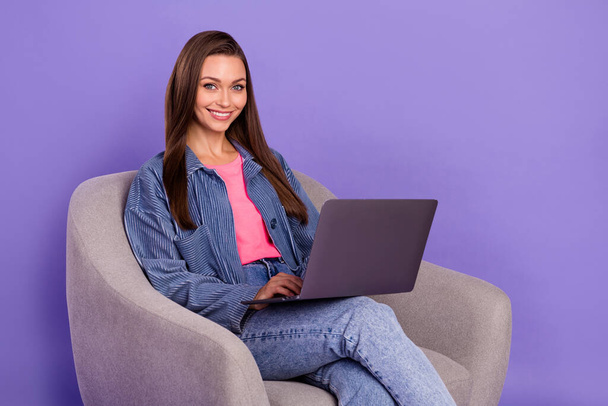 Portrait of cheerful nice person sitting chair toothy smile use wireless netbook coworking isolated on purple color background. - Foto, imagen