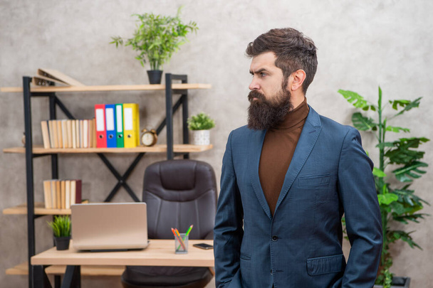 brutal ceo in businesslike suit at the office with copy space, business. - Foto, afbeelding