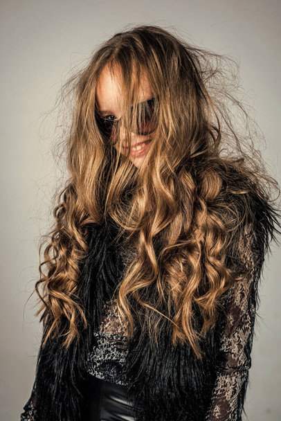 kid in glasses with stylish long curly hair hairstyle, hairdresser. - Foto, Bild