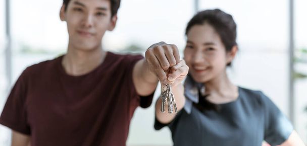 Young Asian couple move into new apartment on Moving Day, celebrating moving to new home concept - Photo, Image