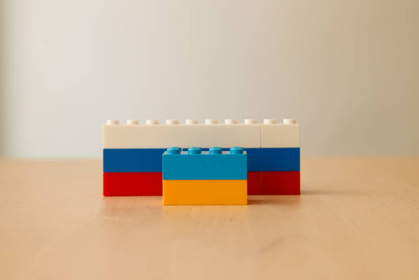 Tell the ukraine russia war with toy blocks. Abstract expressions. Symbols of children's psychology - 写真・画像