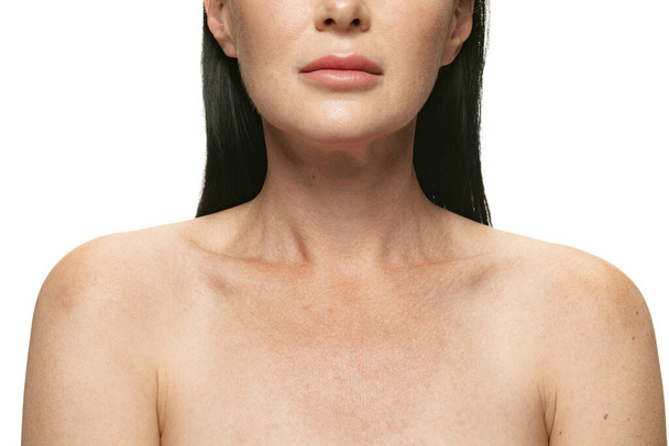 Head, shoulders and collarbones. Close-up female body with first age-related changes isolated on white background. Cosmetics, spa, skin care and beauty concept - Valokuva, kuva