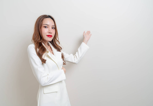portrait beautiful Asian business woman with hand presenting or pointing on white background - Fotoğraf, Görsel