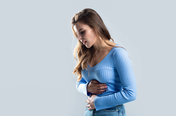 Woman touching his stomach. Stomach pain and others stomach disease concept.Girl having a stomachache. Young woman suffering from abdominal pain. Woman Stomach Ache. - Foto, Imagem