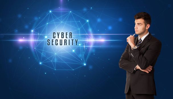 Businessman thinking about security solutions with CYBER SECURITY inscription - Φωτογραφία, εικόνα