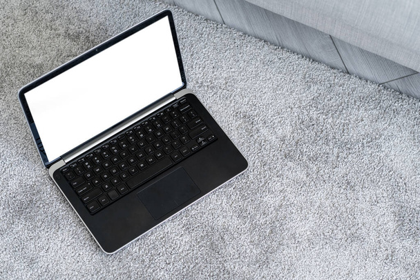 Computer mockup. Online technology. Digital life. Opened laptop with blank screen staying on floor light room interior. - Φωτογραφία, εικόνα