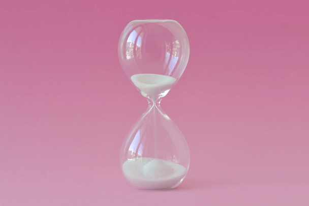 Hourglass on pink background - Concept of health, fertility and biological clock in women - Fotoğraf, Görsel