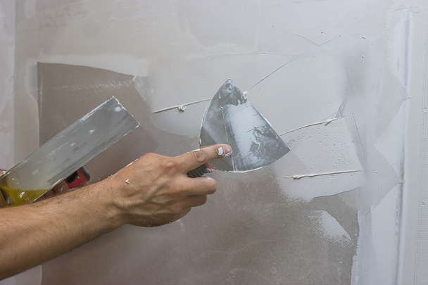 Man hand with trowel plastering a wall 2 - Photo, Image