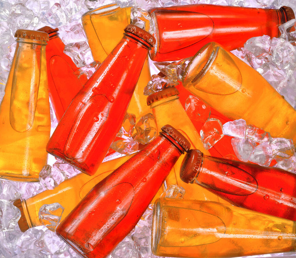 Colorful appetizer drink bottles on ice cellar freezer background. - Φωτογραφία, εικόνα