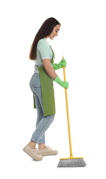 Beautiful young woman with broom on white background - Foto, imagen