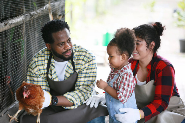 Mixed race family with daughter spending time together at organic's farm. African-American family. - Photo, image
