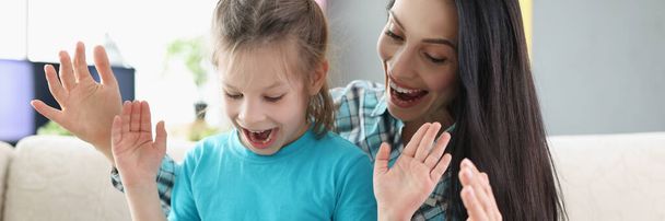 Portrait of happy surprised girl get present from mother, kid open eyes and see decorated box. Cheerful mum congratulate with birthday daughter. Party, gift, family, emotion concept - Fotoğraf, Görsel