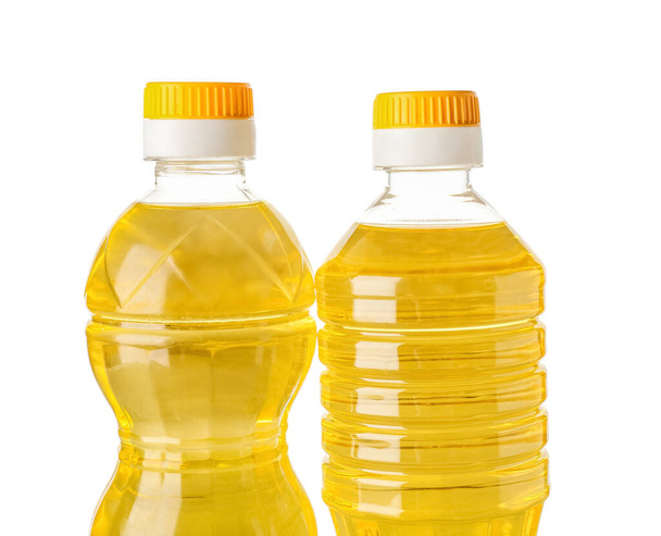 Пляшки з соняшниковою олією на білому тлі, крупним планом
 - Фото, зображення