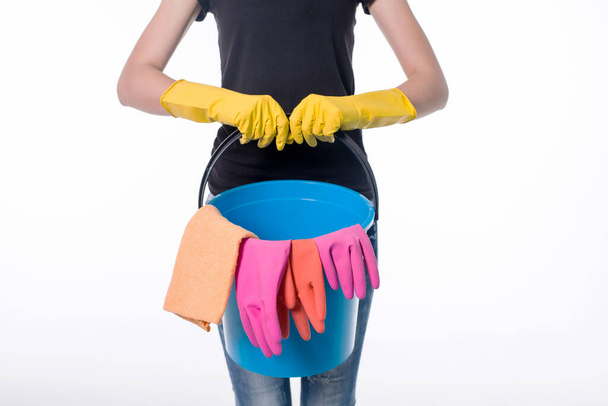 Happy young woman holding a mop and a bucket filled with cleaning products isolated on white background. - Φωτογραφία, εικόνα