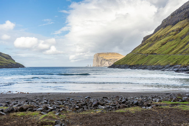 Risin and Kellingin rocks. Sea bay, among beautiful mountains, and beautiful clouds in the blue sky.Tijornuvik bay on Streymoy island. Faroe Islands. Denmark. Europe. Landscapes. Nature. - Фото, изображение