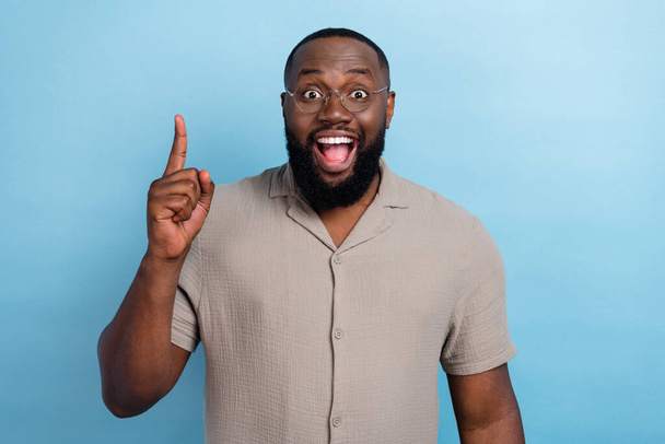 Portrait of astonished positive man point finger brilliant excellent choice isolated on blue color background. - Foto, afbeelding