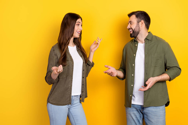Portrait of two friendly cheerful people talk chatting good mood isolated on yellow color background. - Foto, afbeelding