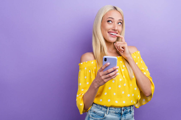 Photo of charming dreamy lady cant wait go on date with her boyfriend surfing on social network isolated on violet color background. - Foto, afbeelding