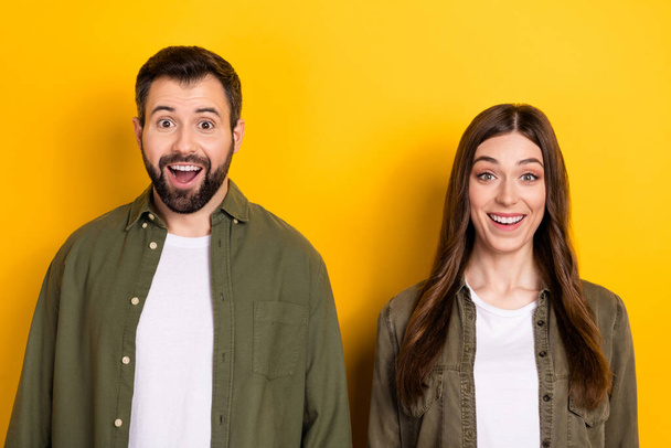 Photo of two astonished positive people stare speechless cant believe isolated on yellow color background. - Φωτογραφία, εικόνα