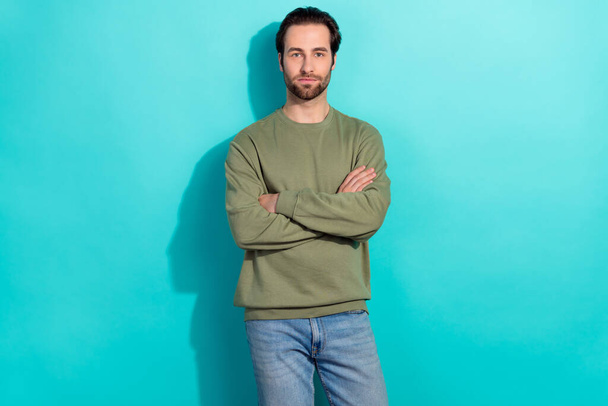Photo of nice brunet millennial guy crossed palms wear green shirt isolated on teal color background. - Foto, imagen