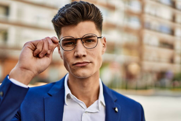 Young man relaxed wearing suit and glasses at street - Valokuva, kuva
