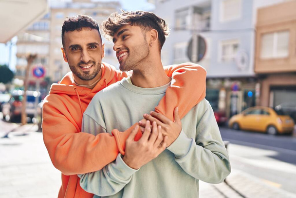 Two man couple hugging each other standing at street - Photo, Image