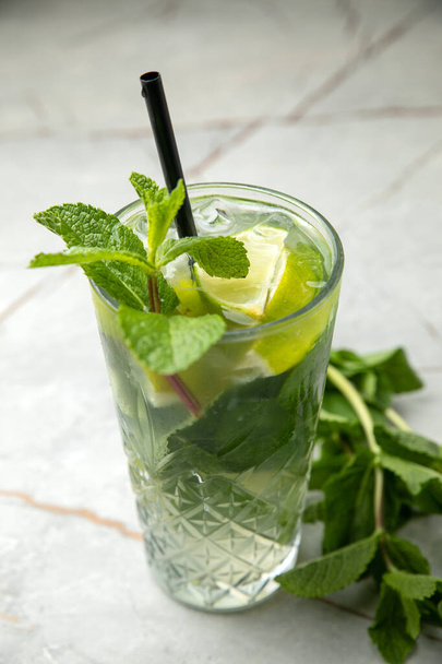 glass of fresh lemonade with mint and rosemary on a dark background - Fotó, kép