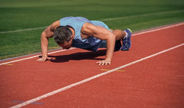 sport success. male athlete do morning exercise. pushups workout. sportsman planking outdoor. health care. muscular guy training core muscles. man in plank. healthy lifestyle routine. - Photo, Image
