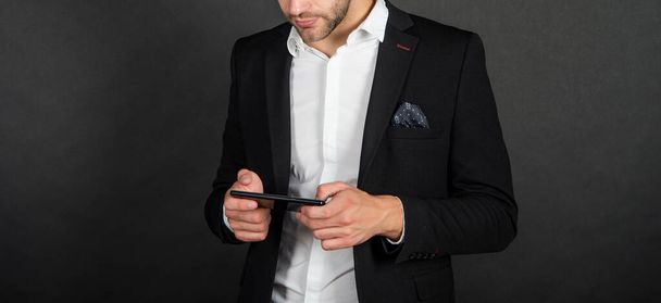 cropped guy in jacket messaging on smartphone, communication. - Foto, immagini