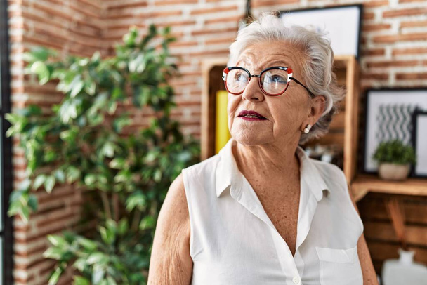 Senior grey-haired woman smiling confident standing at home - Photo, Image